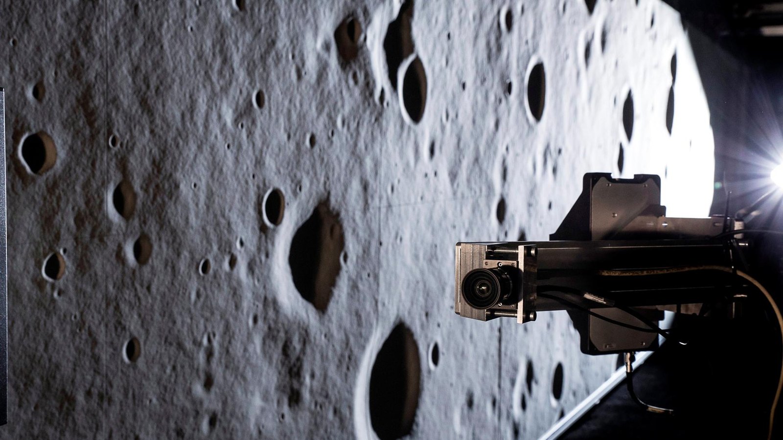 Camera on a robotic rail facing the milled lunar terrain wall inside TRON